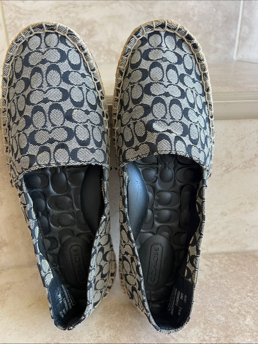 Coach women’s Signature Canvas Slip-Ons in Black and Beige